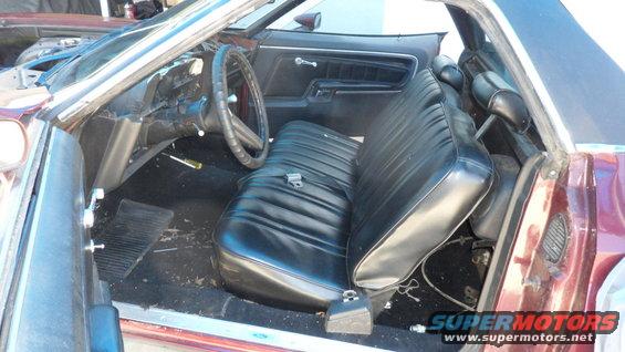 Maroon 1972 Ford Ranchero interior with black vinyl bench seat and dashboard