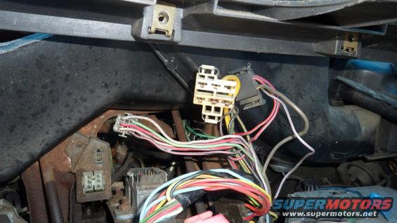 Close-up of a car's interior wiring harness with many colorful wires and connectors