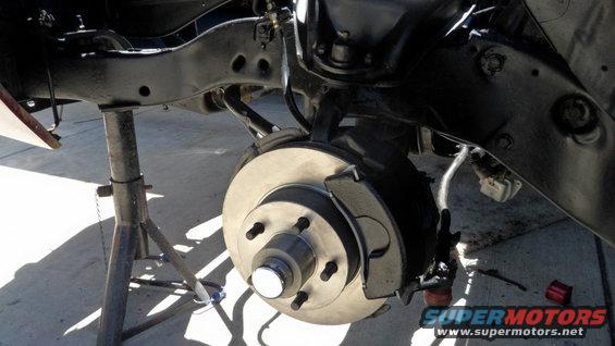 vehicle's front disc brake assembly on jack stands
