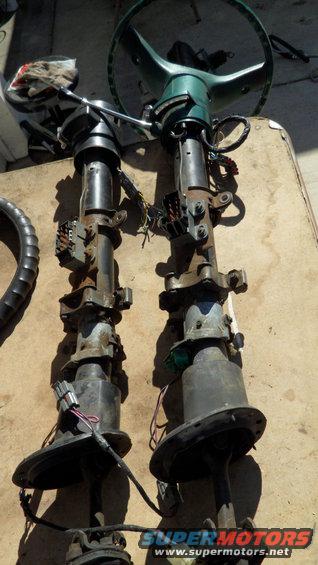 two car steering columns with wiring harnesses