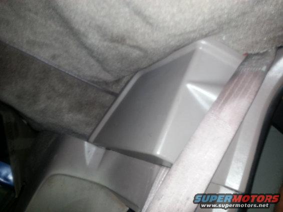 Interior trim panel and seatbelt in a vehicle