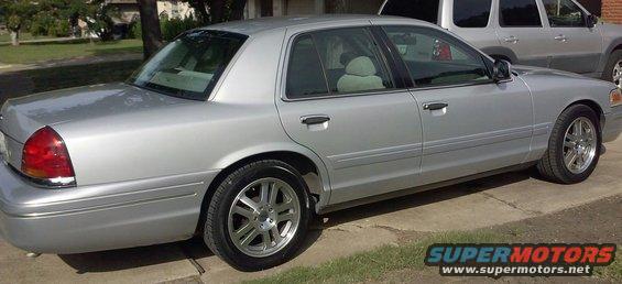 Silver sedan parked on a driveway, another SUV behind it