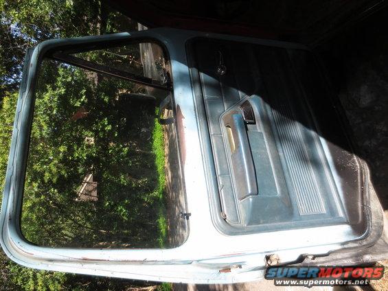 Light blue car door with interior panel and window frame