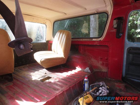 Interior of a 1978 Ford Bronco, showing the passenger seat, rear floor, and seatbelt