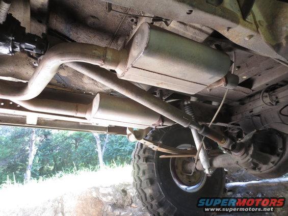 Undercarriage view of dual exhaust system and leaf springs on a vehicle