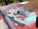 1978 Ford Bronco - A car hood shows areas of exposed metal and body filler, indicating repair work.