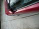 1993 Mazda MX-3 - Side view of a red car, highlighting the wheel spacers and rims.