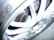 1993 Mazda MX-3 - A close-up view of a car's wheel, tire, and brake assembly.