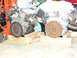 1993 Mazda MX-3 - Two disassembled car engines are supported by wooden blocks and an engine hoist in a workshop setting.