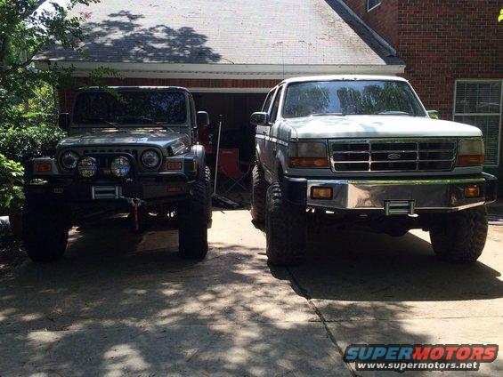 Front view of a lifted 1994 Ford Bronco with a chrome bumper and winch