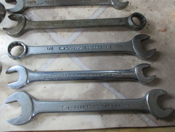 Several open-end and box wrenches laid out, including Blackhawk and Proto brands
