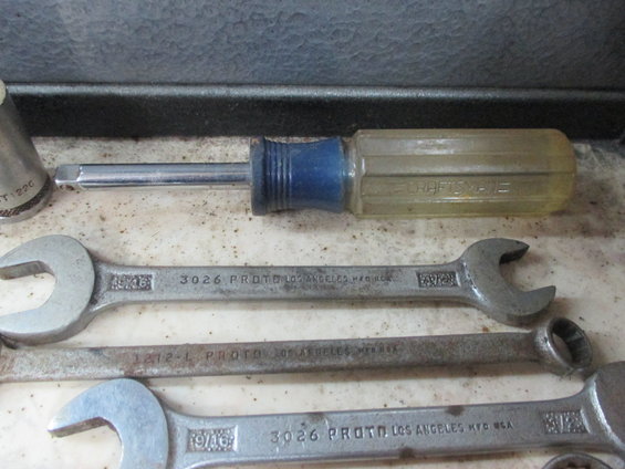 Wrenches and a screwdriver on a surface. The wrenches have text like "3026 PROTO LOS ANGELES MFG. USA"