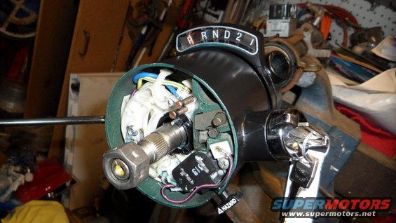 Steering column with gear selector showing R N D 2 1, hazard switch, and wiring