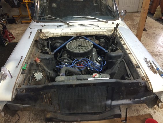 1964 Ford Fairlane engine bay with V8 engine and blue spark plug wires