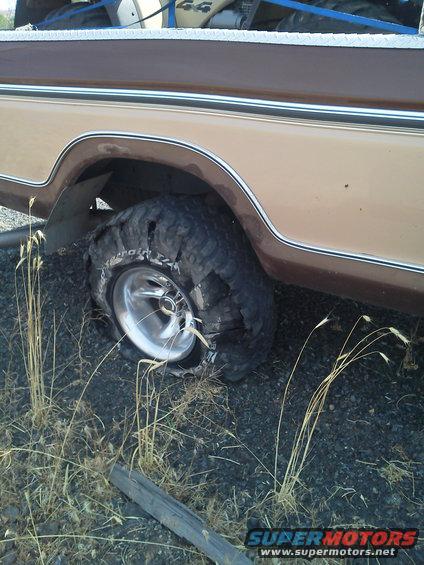 1979 Ford F-150 with a flat rear tire and chrome rim
