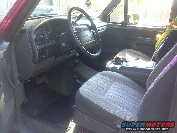 Interior of a truck, showing dashboard, steering wheel, and seats