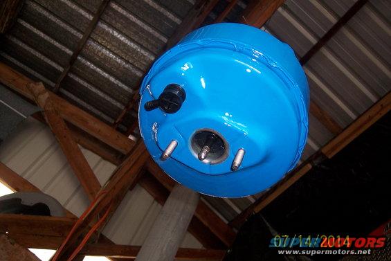 Blue brake booster with mounting studs and vacuum port