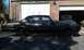 1966 Oldsmobile Cutlass - This 1966 Oldsmobile Cutlass sedan is on jack stands in front of a garage, undergoing maintenance.