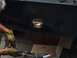 1997 Dodge 3500 - A person is welding a hole in a black metal surface, with sparks flying and a cardboard box in the background.