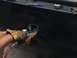 1997 Dodge 3500 - A person in a work glove uses a grinder on a black vehicle part, creating a shower of sparks.