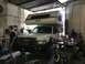 1997 Dodge 3500 - A white Dodge pickup truck is parked inside a garage, fitted with a Lance camper shell on its bed.