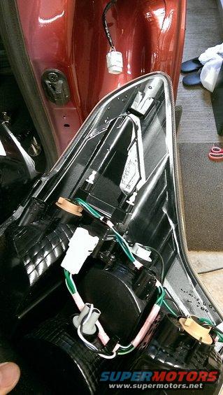 Backside of a car taillight assembly with wiring harnesses and connectors