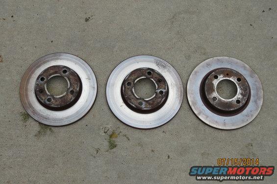 Three brake rotors on concrete. Date stamp reads 07/15/2014