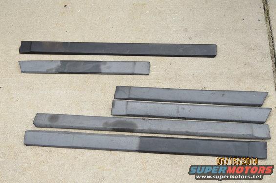 Set of car door trim pieces, some dark, some gray