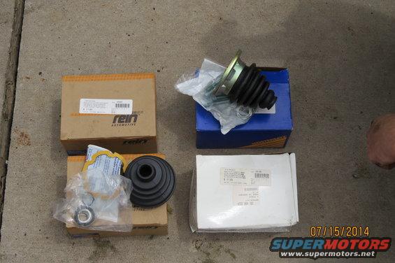 CV joint and dust boot parts in boxes, one labeled Rein Automotive
