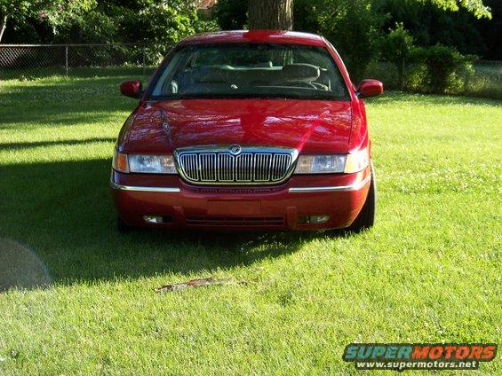 1999 Mercury Grand Marquis front view, parked on grass with trees in background