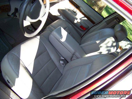 Tan leather interior of a 1998 Mercury Grand Marquis, showing front and rear seats, center console, and dashboard