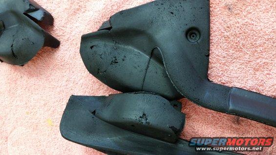 Black plastic car parts on pink towel