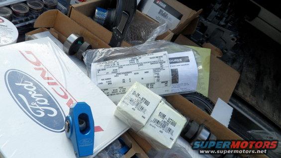 Ford Racing box, blue rocker arm, and various bagged parts