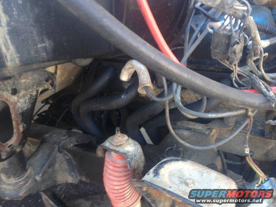 Engine bay view showing exhaust manifold and wiring