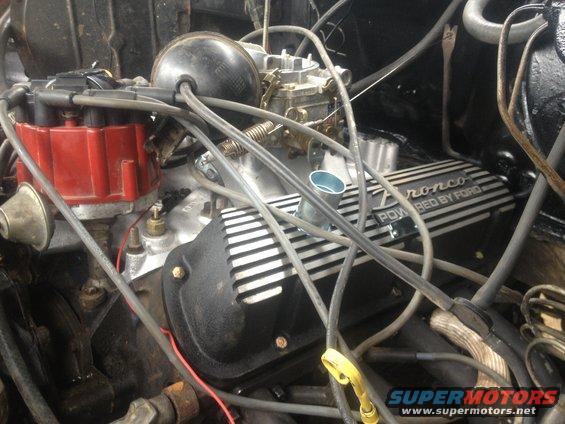 Close-up of a Ford Bronco engine with "Bronco POWERED BY FORD" valve covers