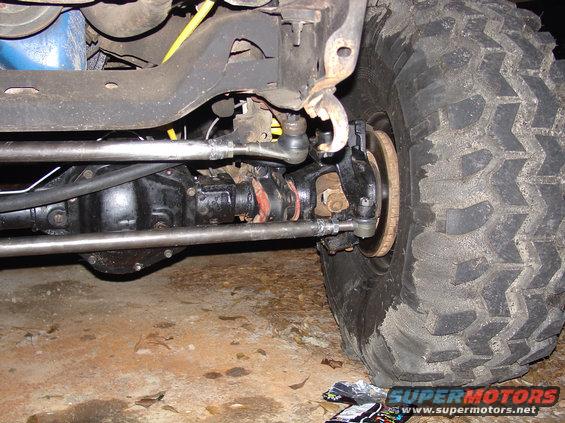 Front axle assembly with steering linkage and large tire