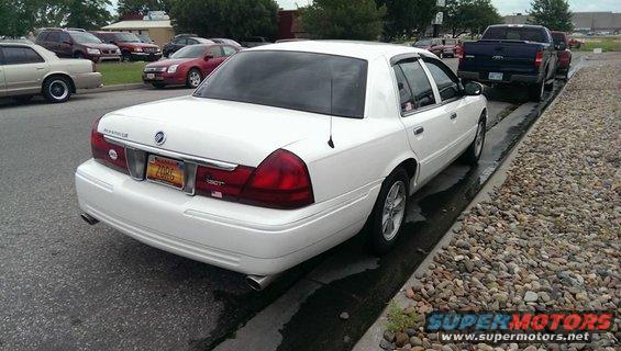 White 2000 Mercury Grand Marquis parked on street, rear view