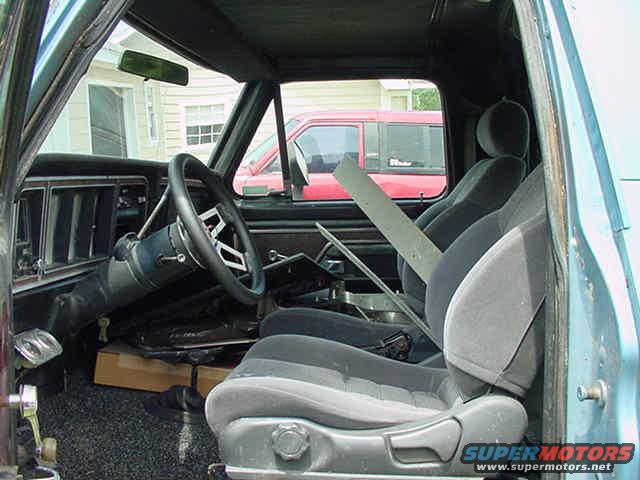 Interior of a 1979 Ford Bronco, showing the driver's seat, steering wheel, and dashboard
