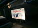 1997 Dodge 3500 - Close-up of a vehicle's front bumper, showing a California license plate with obscured characters.