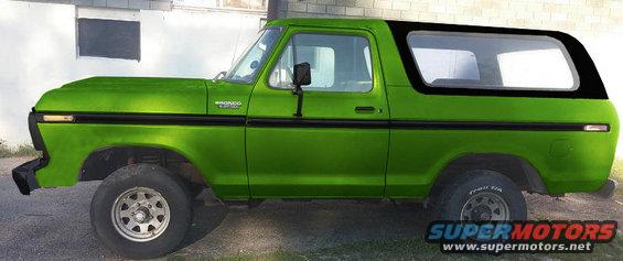 Green 1978 Ford Bronco with black top, side view