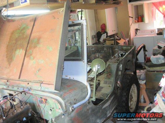 Jeep body with hood open, in a garage setting