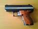 2003 Ford Crown Victoria - A Hi-Point Firearms Model CF380 pistol chambered in 380 ACP rests on a wooden surface.