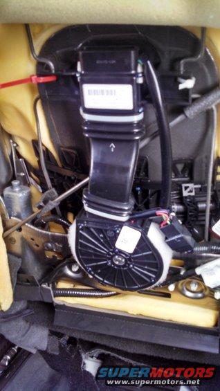 Car seat interior showing ventilation fan and ducting assembly with wiring