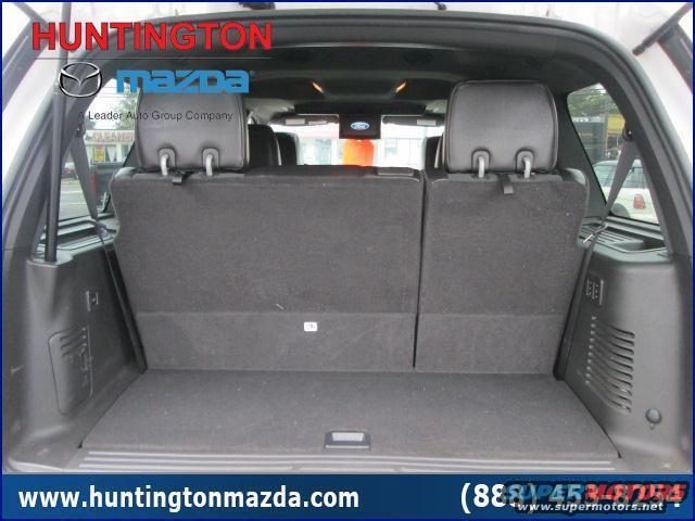Black SUV trunk interior with folded down seats and side panel vents