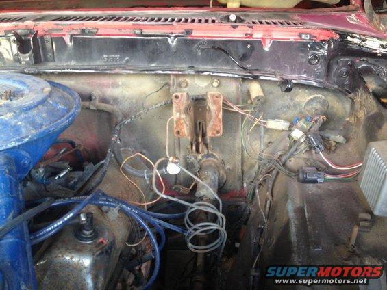 Engine bay showing brake master cylinder and wiring