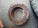 1978 Ford Bronco - This heavily rusted brake rotor shows significant damage to its outer teeth, indicating wear and tear.