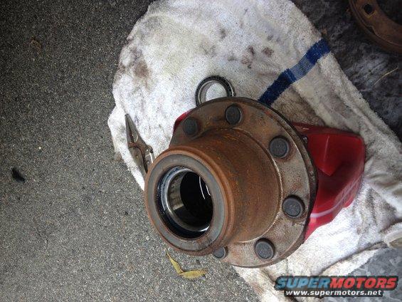 Wheel hub and red brake caliper on towel