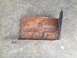 1978 Ford Bronco - This heavily rusted metal bracket has stamped markings and appears to be a vehicle part.