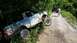 2014 Ford Bronco - A man pulls a stuck off-road vehicle out of the mud on a dirt path.
