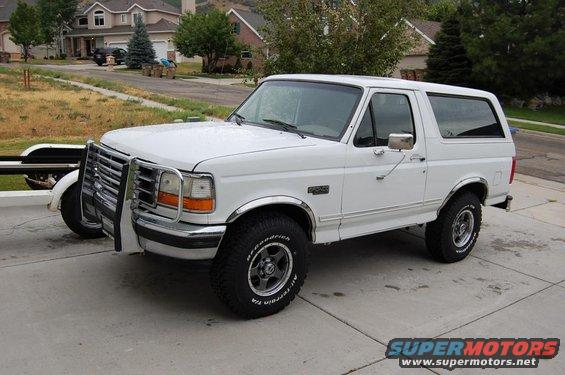 White 1995 Ford Bronco with chrome brush guard parked on a driveway